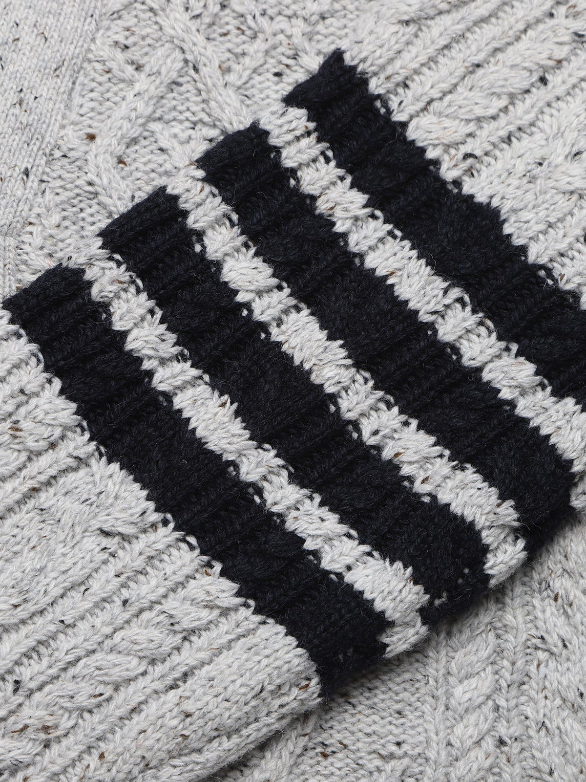 Cable knit cardigan by Thom Browne, knitwear detail view