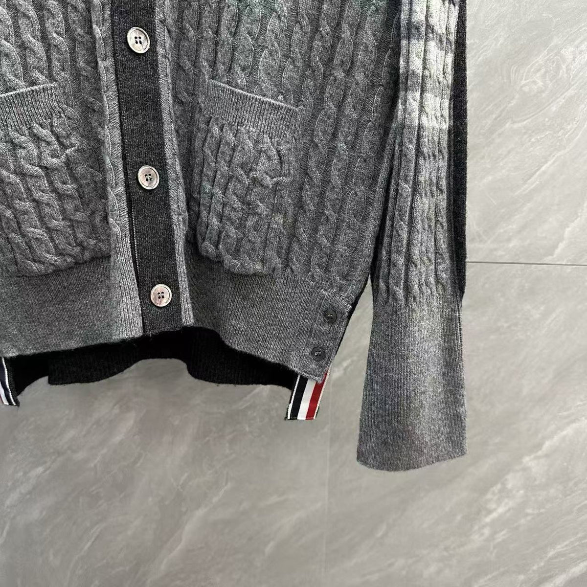 Unisex Two-Tone Cable Knit V-Neck Cardigan - Grey Wool by Thom Browne, outerwear detail view