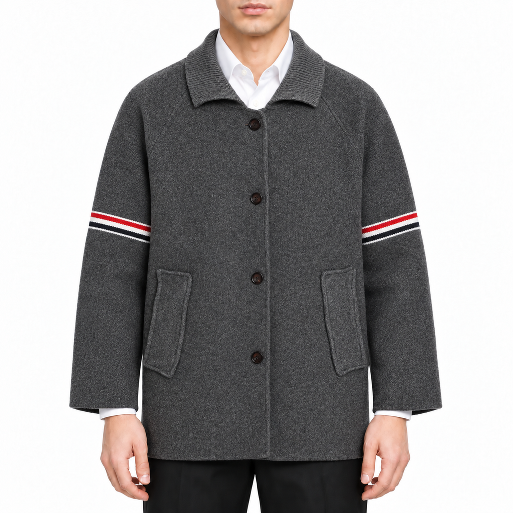 Unisex wool coat with webbing sleeves by Thom Browne, modeled on a pure white background