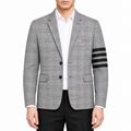 Plaid suit by Thom Browne, modeled on a pure white background